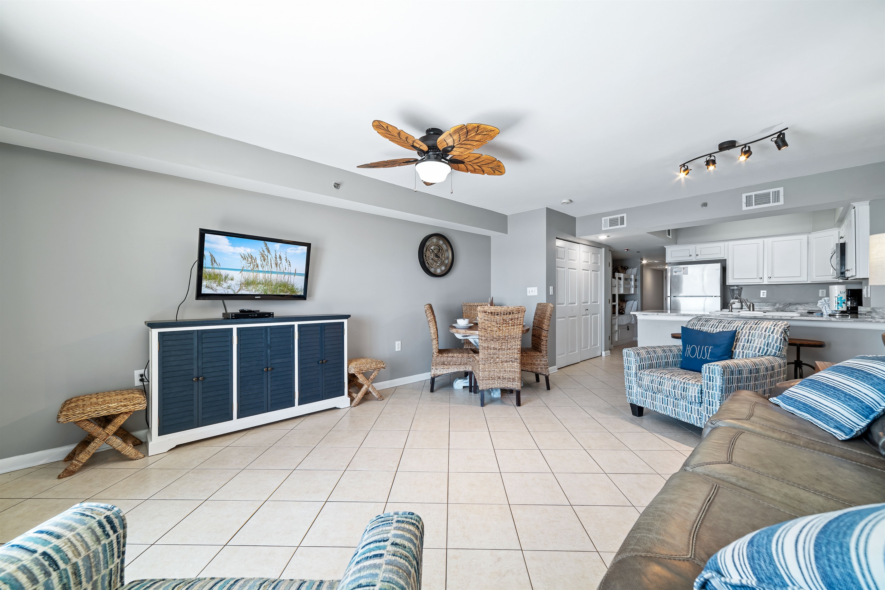 This well-appointed living space offers a comfortable sleeper sofa, flat-screen TV, and a dining area with seating for four, creating a welcoming atmosphere.