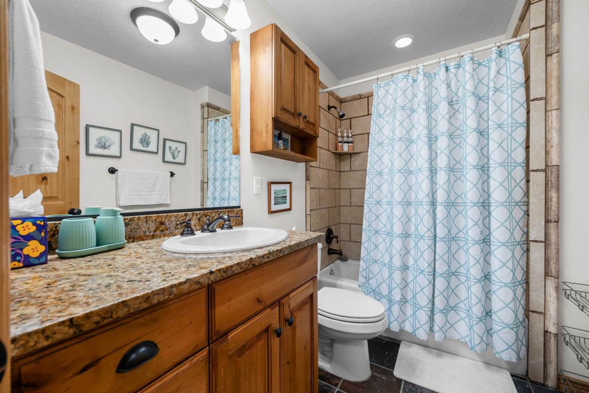 The ensuite bathroom offers a spacious granite countertop and a convenient shower/tub combination.