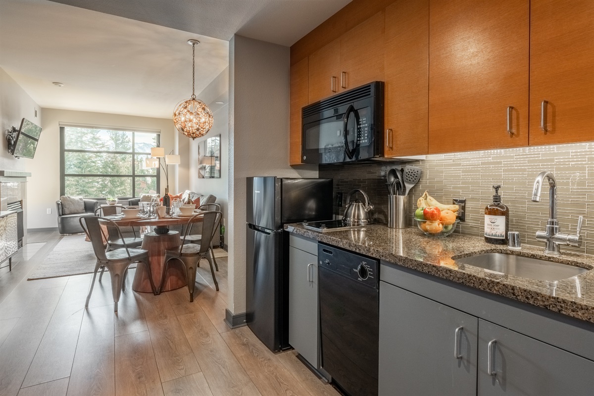 A bright, efficient kitchen is set within the larger living space, making cooking and snacking convenient.