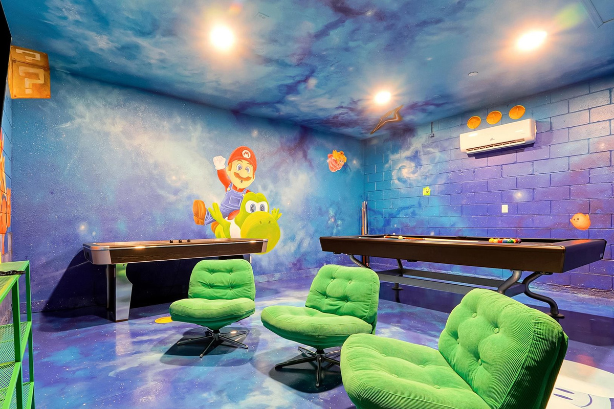 Mario Galaxy Games Room: Comfortable gaming chairs, a large TV, Nintendo Switch, pool table and air hockey offer entertainment for every age.