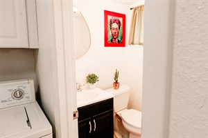 A sparkling white toilet stands beside a sleek washer, embodying the pinnacle of modern convenience and hygiene.
