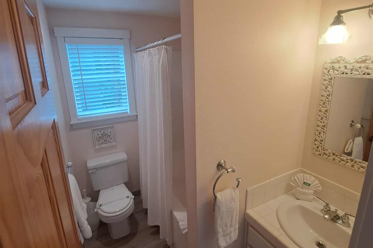 Full bathroom with plenty of soft, white towels.