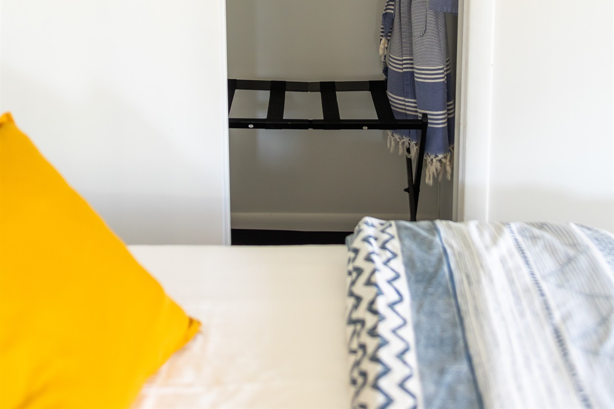 Closet space with luggage rack & bath robes