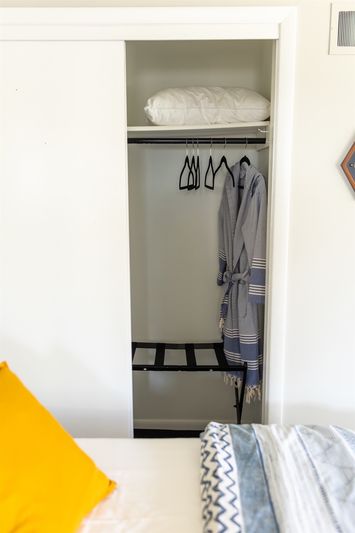 Closet space with luggage rack & bath robes