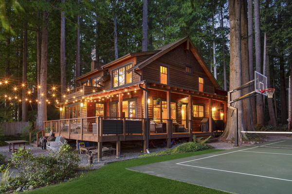 Another view of the house, tucked into the trees with the lake just beyond.