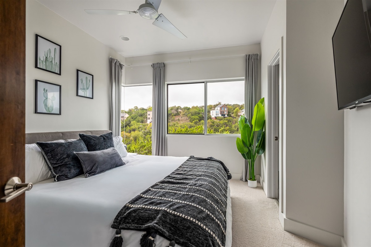 Calm bedroom with plush bedding and scenic views