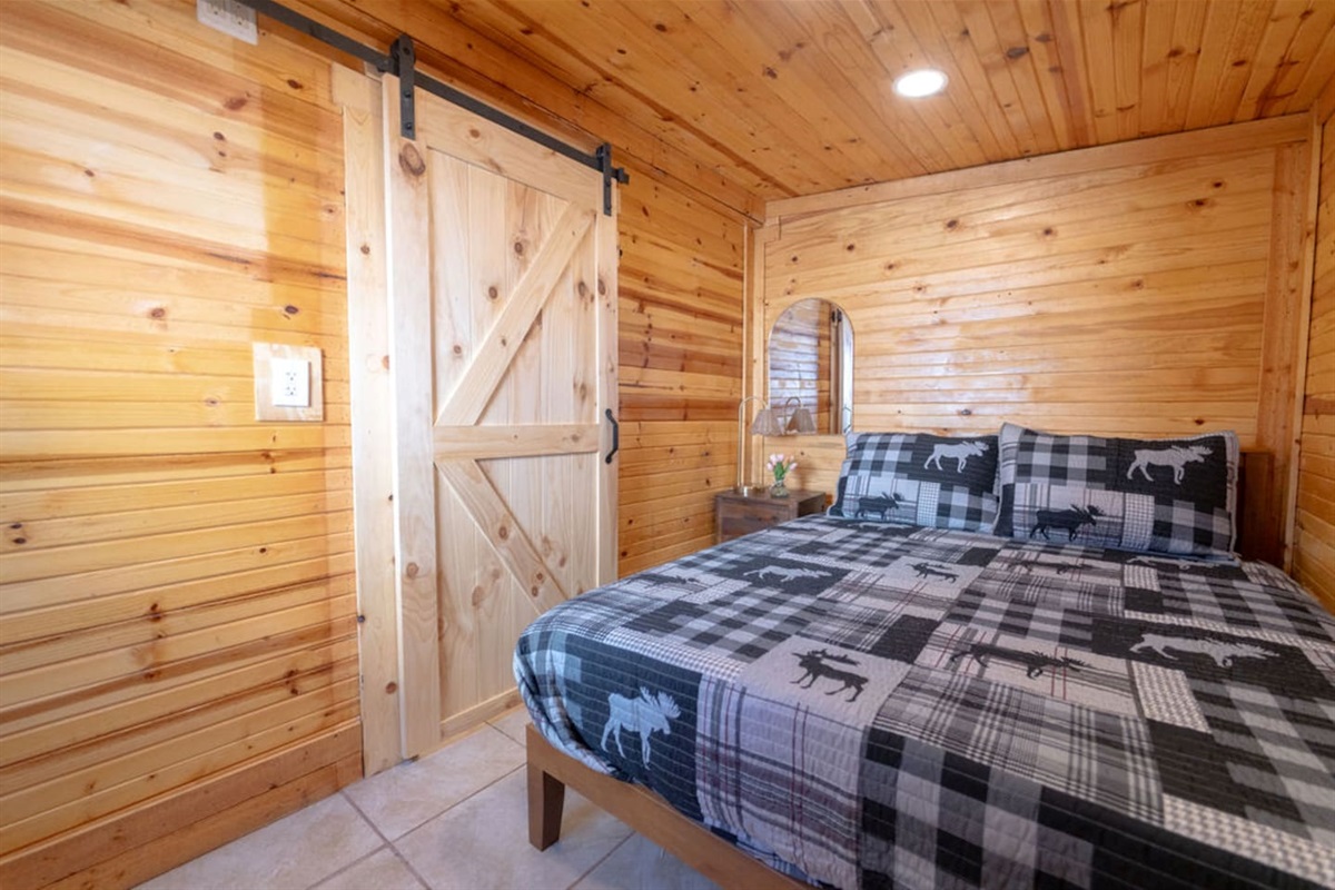 Welcome to your cozy cabin retreat, where rustic charm and comfy vibes meet! Slide the barn door shut for ultimate relaxation, snuggle into the plush queen bed, and let the cabin magic do the rest!