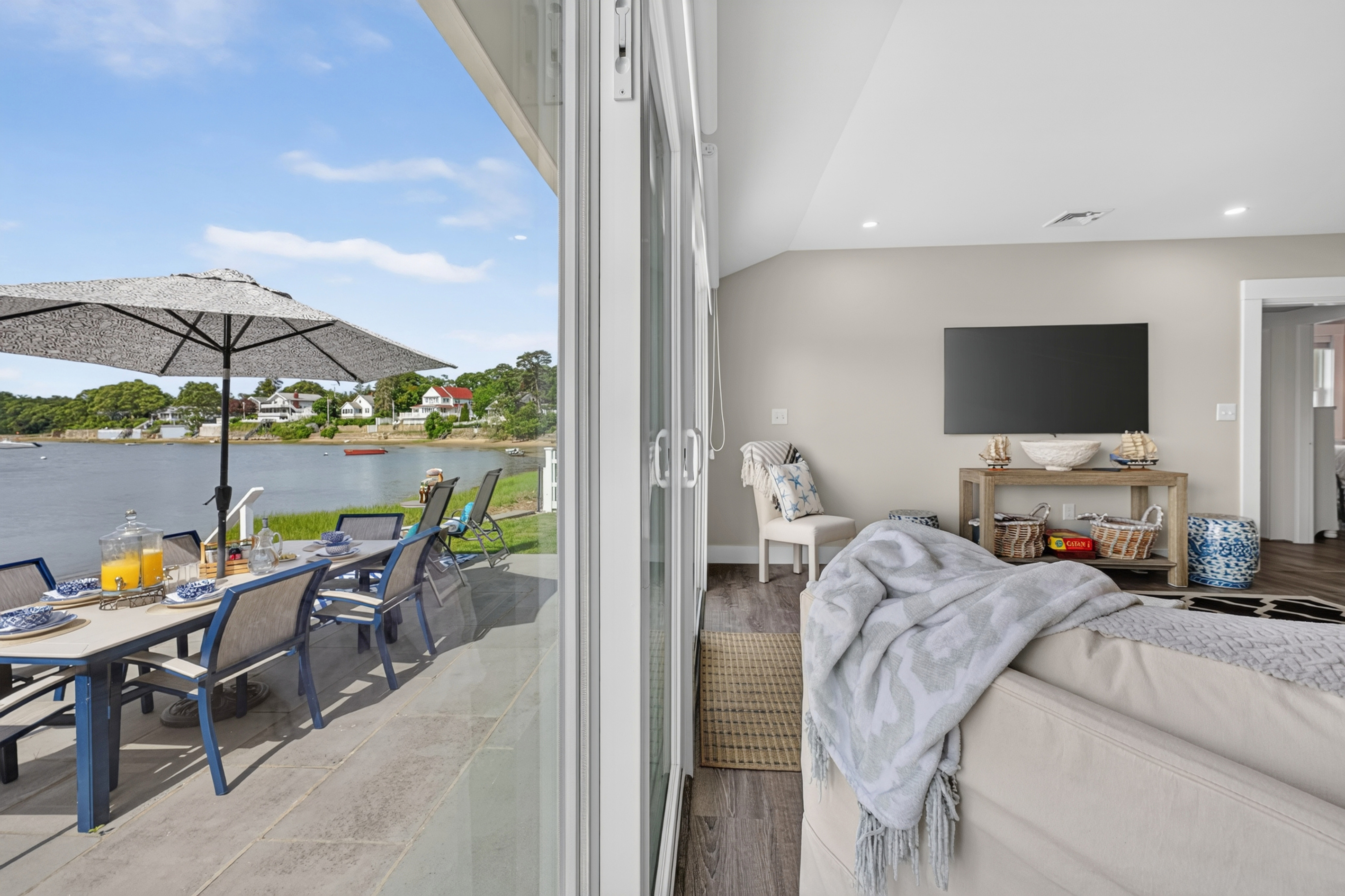 Bedroom with direct access to the outdoor patio, offering peaceful water views and abundant natural light.