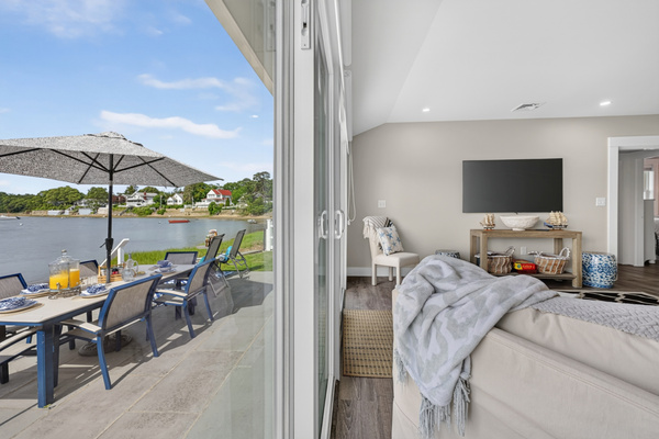 Bedroom with direct access to the outdoor patio, offering peaceful water views and abundant natural light.