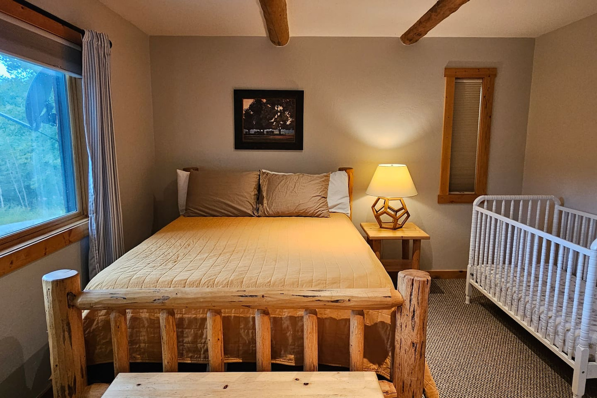 Bedroom 3 - queen bed, walk-in closet with dresser, and crib. Crib sheets, baby monitor, and highchair are available upon request.