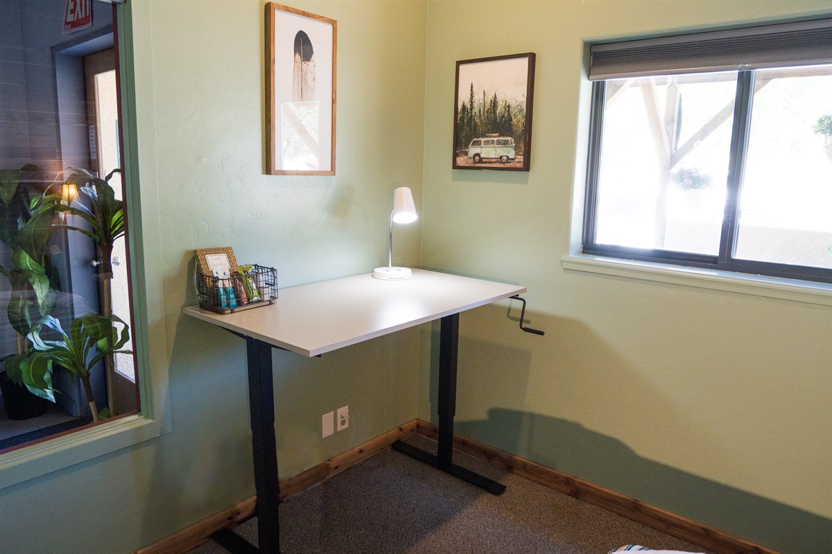 Large adjustable height desk and a wireless-charging lamp that will charge your compatible devices