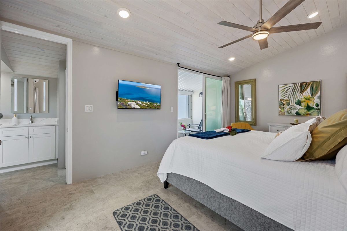 Guest bedroom with king bed and balcony