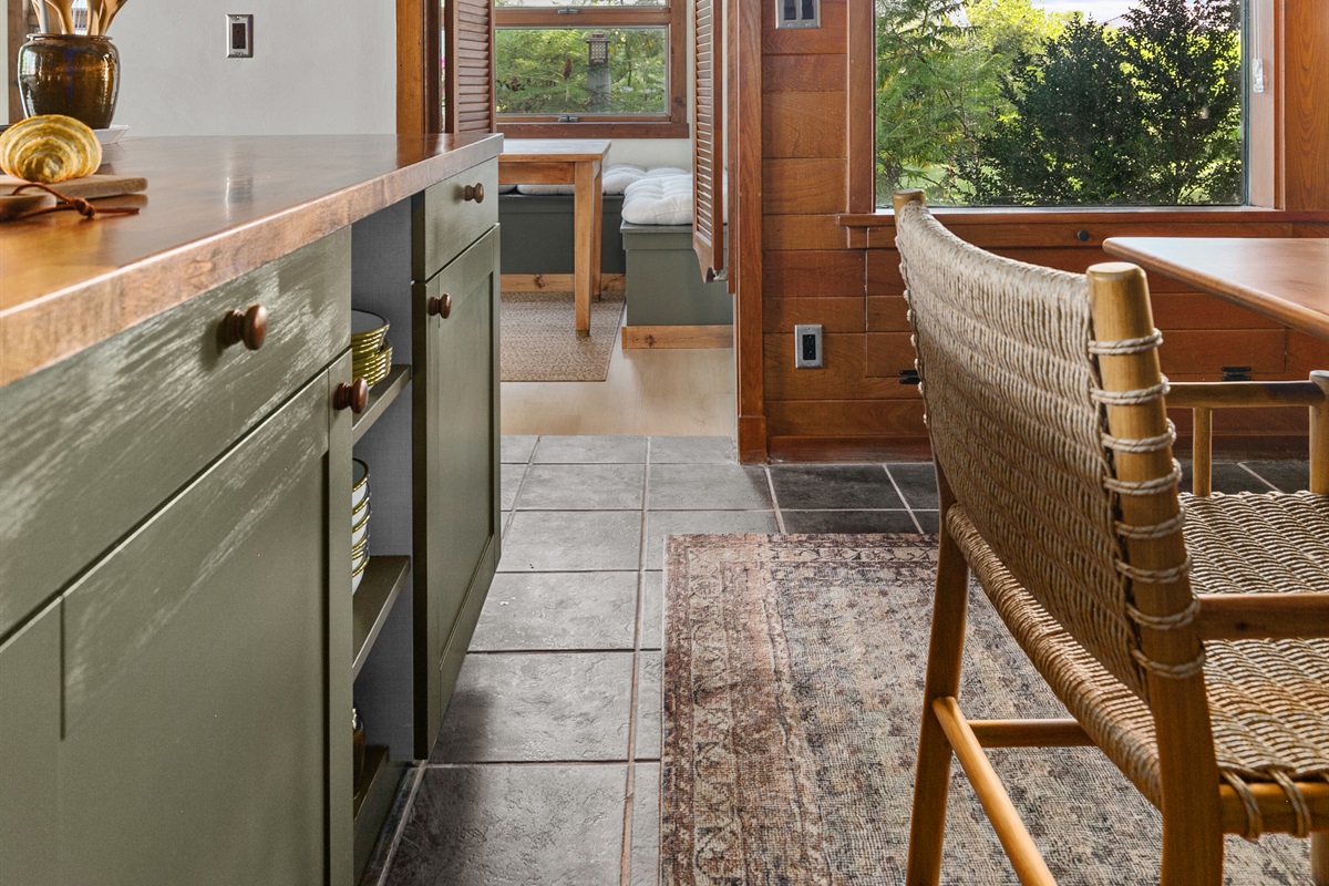 The kitchen island offers built-in storage, stocked with all the dishes you’ll need for your stay.