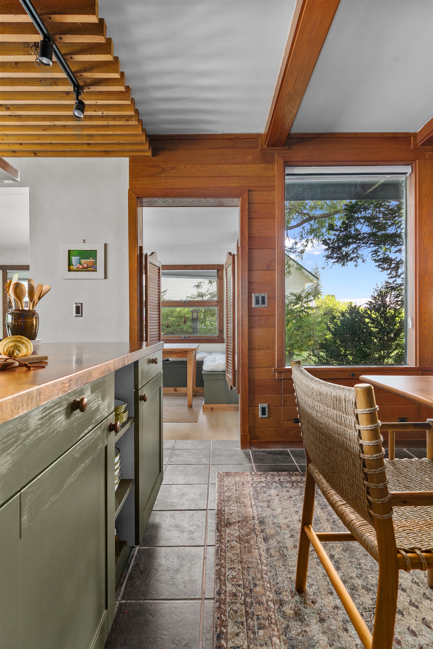 The kitchen island offers built-in storage, stocked with all the dishes you’ll need for your stay.