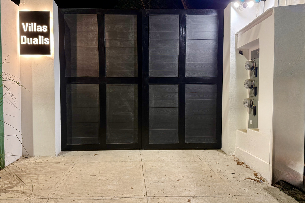 Villas Dualis gate — backlit sign, keyless entry.