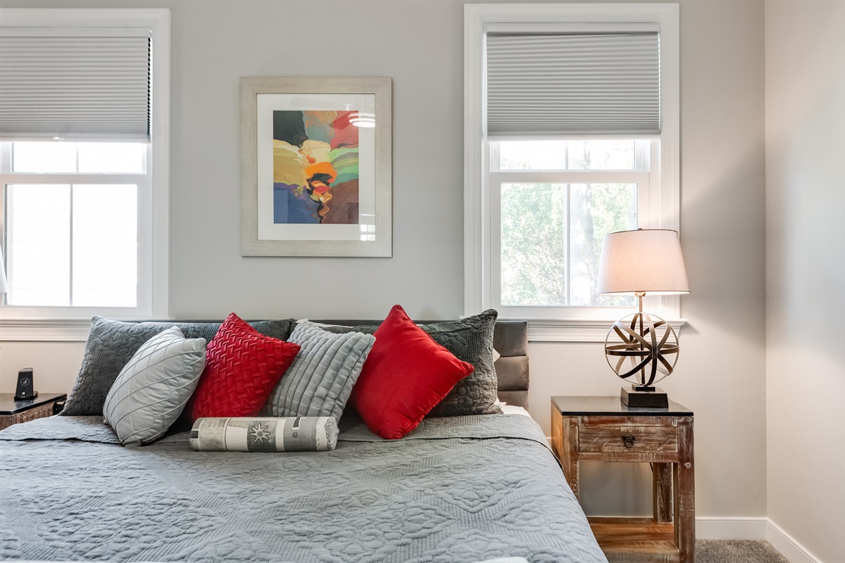 King Bedroom 1: Bright and inviting room with artistic decor and plush bedding!