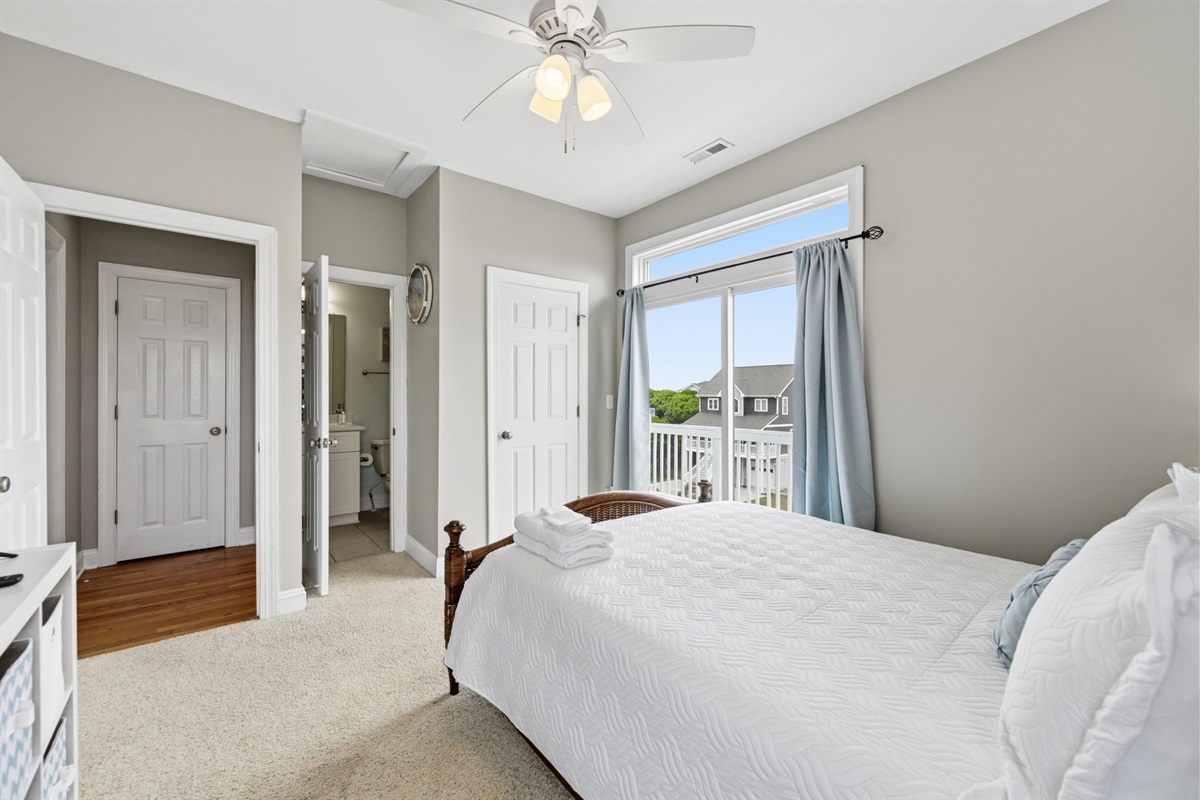Top floor bedroom with king bed and private balcony access