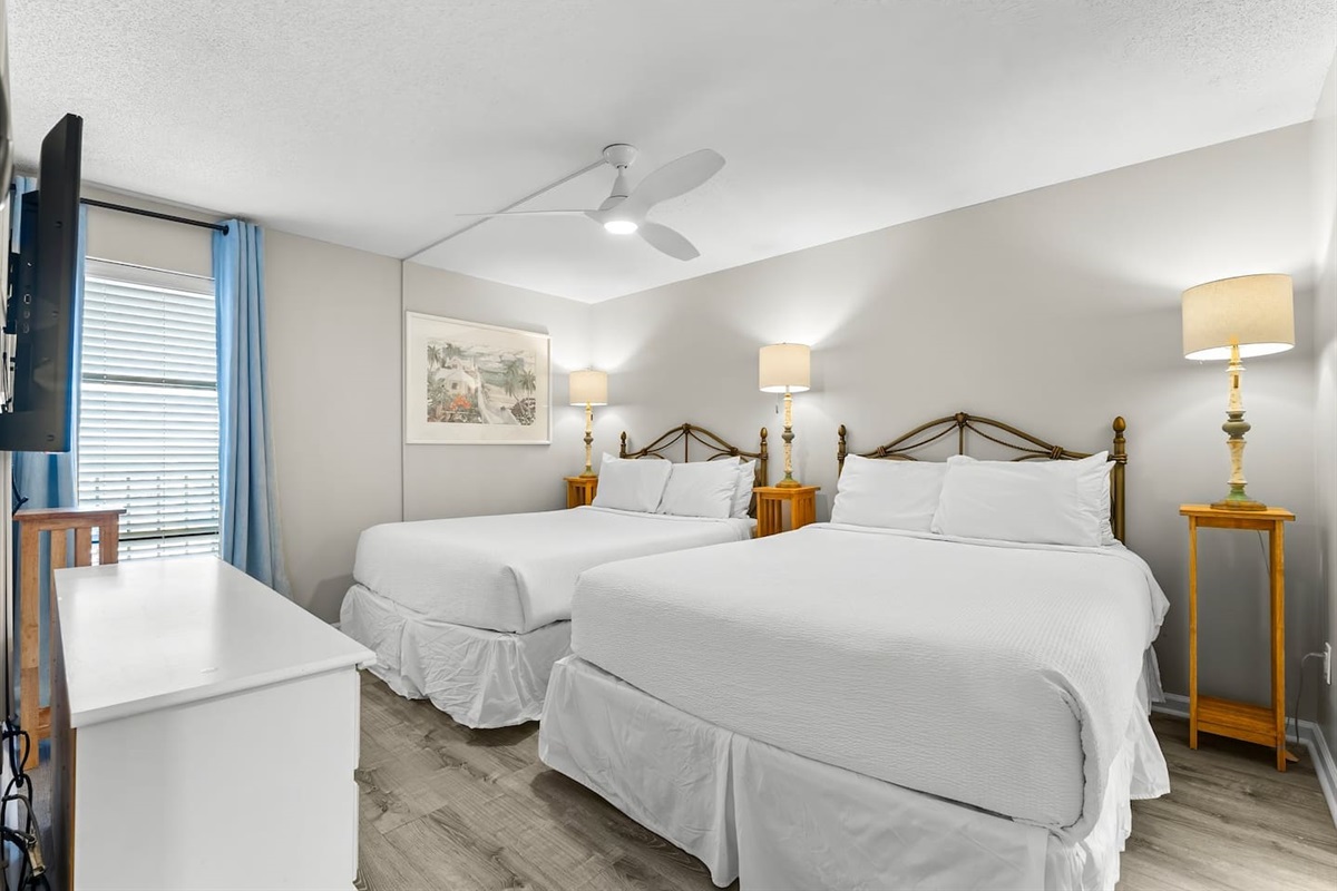 Guest bedroom with two queens, ceiling fan, smart TV