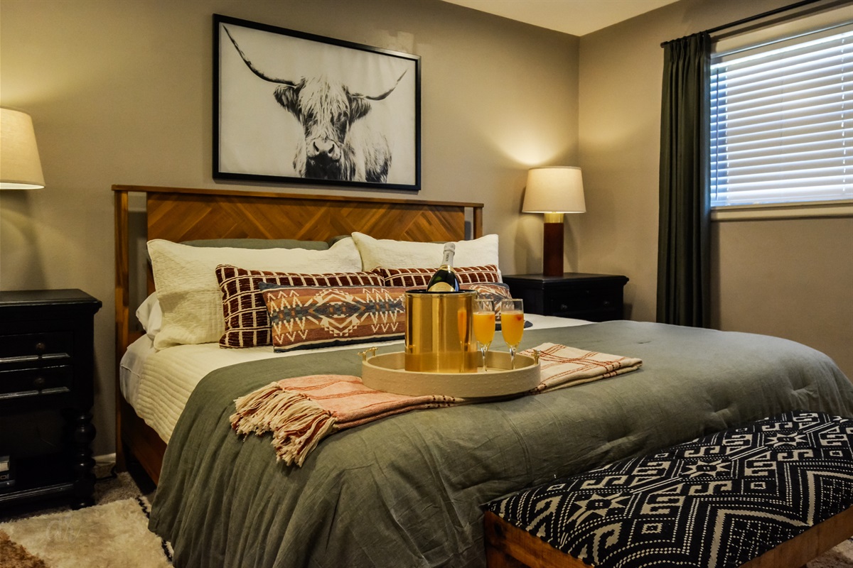 Sip, Relax & Celebrate Texas-Style 🥂 → A cozy king bed and a touch of luxury — your Abilene retreat awaits.