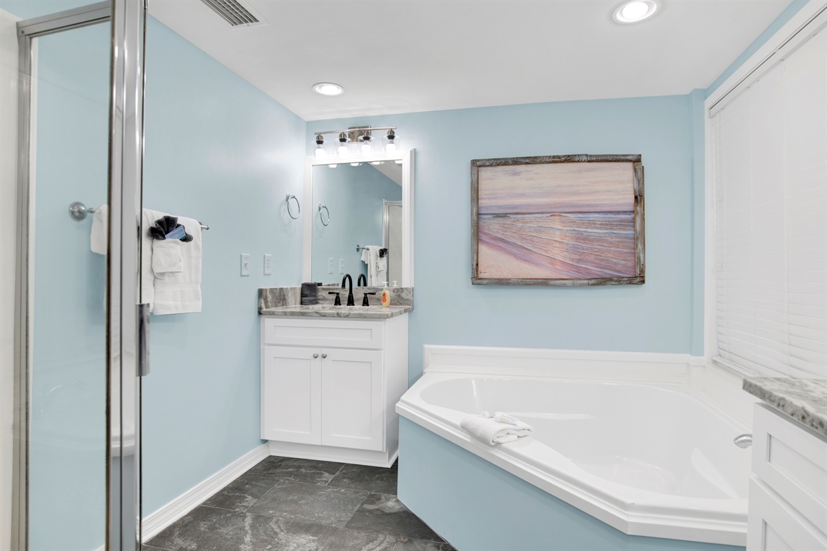 Primary Bathroom with 2 vanities, soaker tub, stand up shower and water closet toilet area