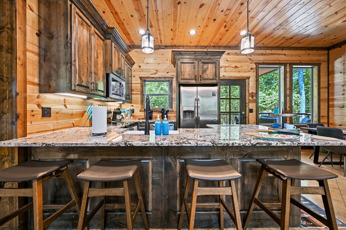 A cook’s dream kitchen with modern appliances, beautiful finishes, and room for everyone to gather around.