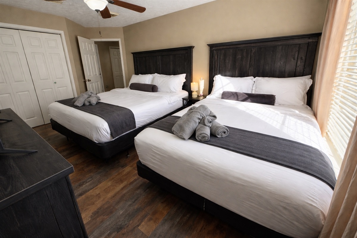 Designed for comfort and flexibility, this large bedroom offers a King and Queen bed plus a 55” Smart TV. Ideal for families, group stays, or guests who want extra space to relax.