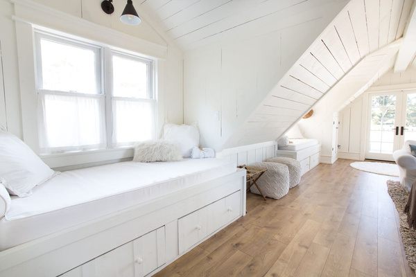 Claim a window nook for an afternoon nap, a few chapters or a little daydreaming. These two built-in twin XL beds tuck beneath the eaves in the upstairs living room, giving everyone a cozy spot of their own.