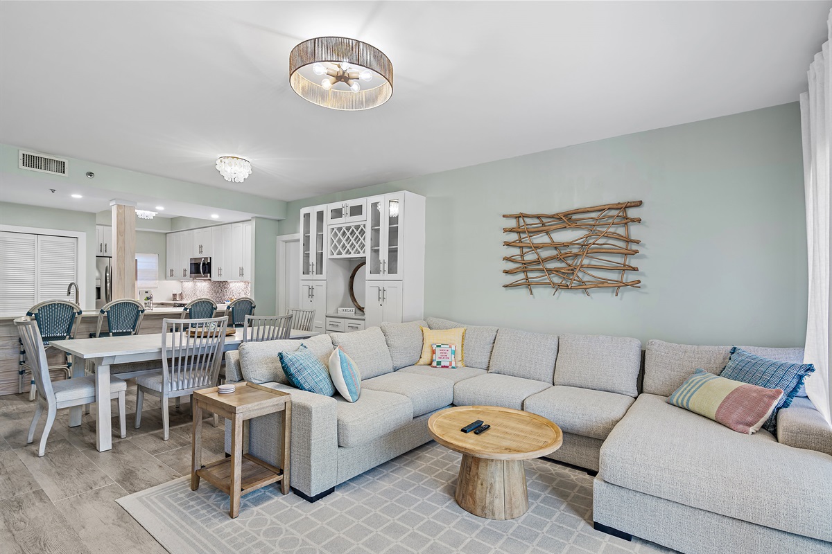 Stunning Living Room with Large, Comfortable Sectional, 75" Smart TV, electric fireplace, and patio access