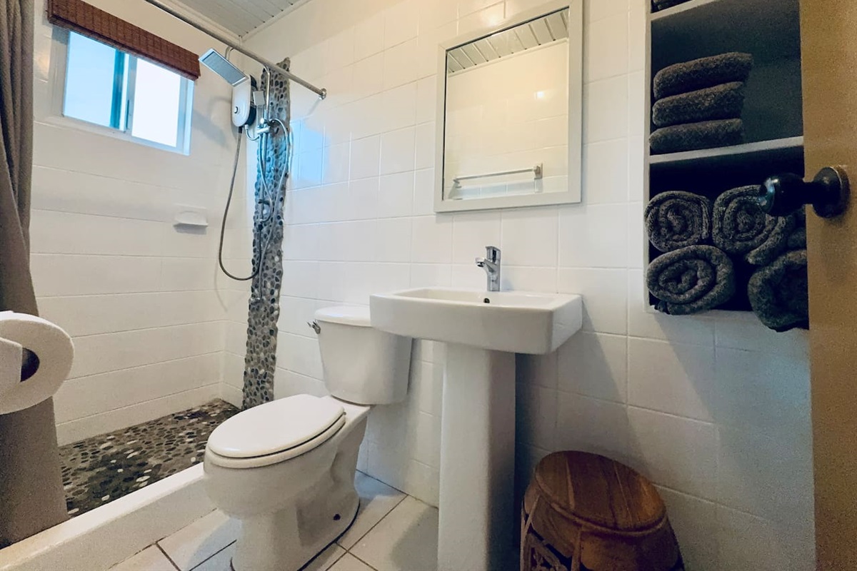 This bathroom is shared with bedroom 1 & 2.   Guest staying in bedroom 1 will enter bedroom 2 to access bathroom. 
Guest in bedroom 2  must walk through bedroom 1 to access living room, kitchen and outside. 