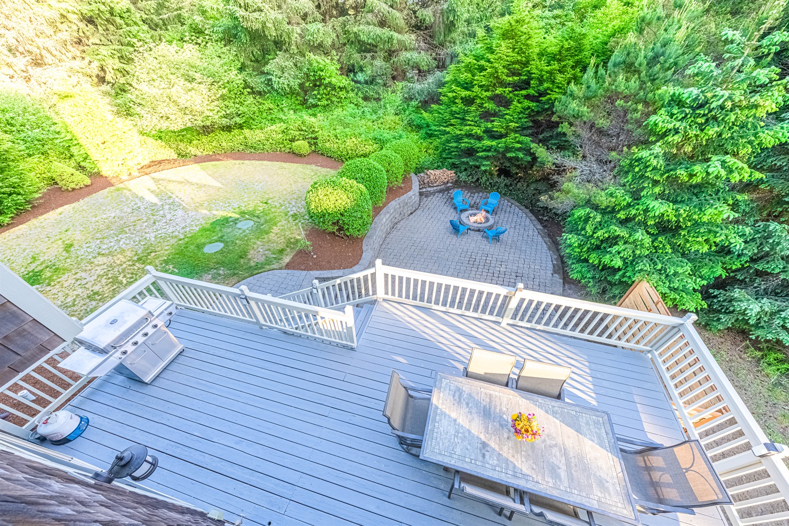 250 sq ft deck overlooking an 1,100 square ft patio w/fire pit.  Mature landscaping makes for a very private back yard.