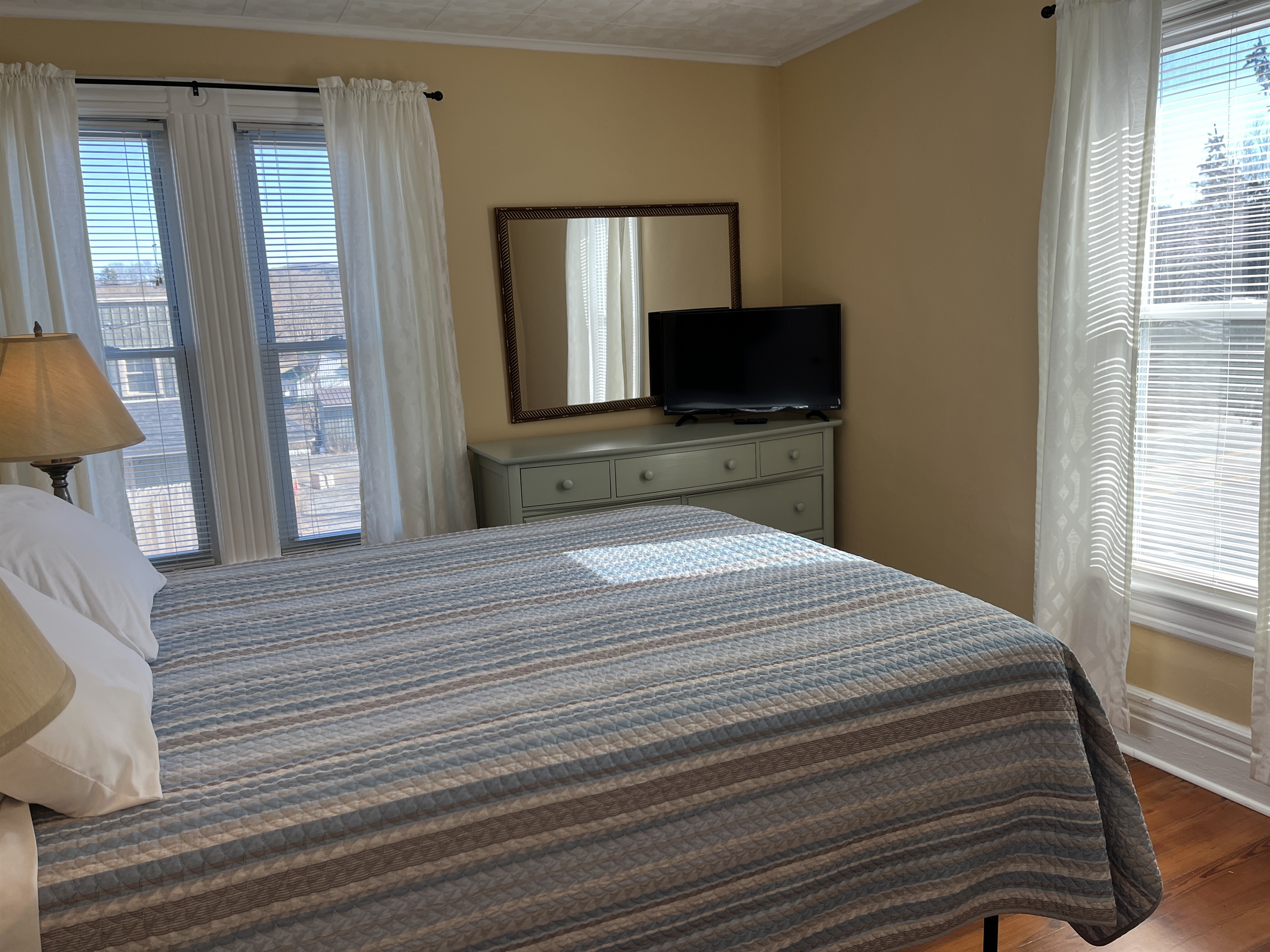Cooperstown Cottage 2nd floor primary bedroom with queen bed and smart TV.