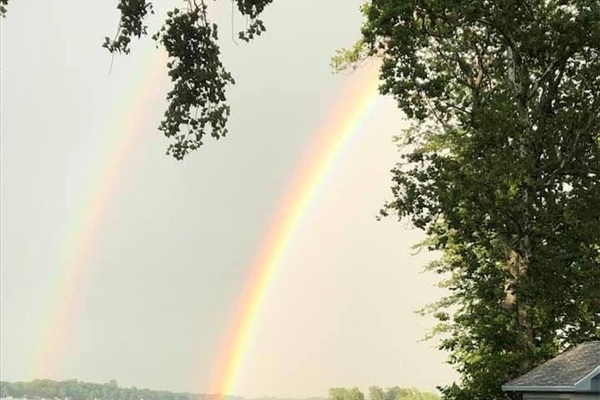 Rainbow over Paw Paw Lake — unforgettable lakefront moments.