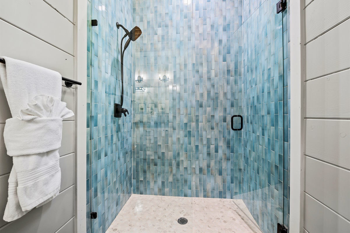 Step into a shower experience with stunning blue tiles that transport you to a tranquil oasis.