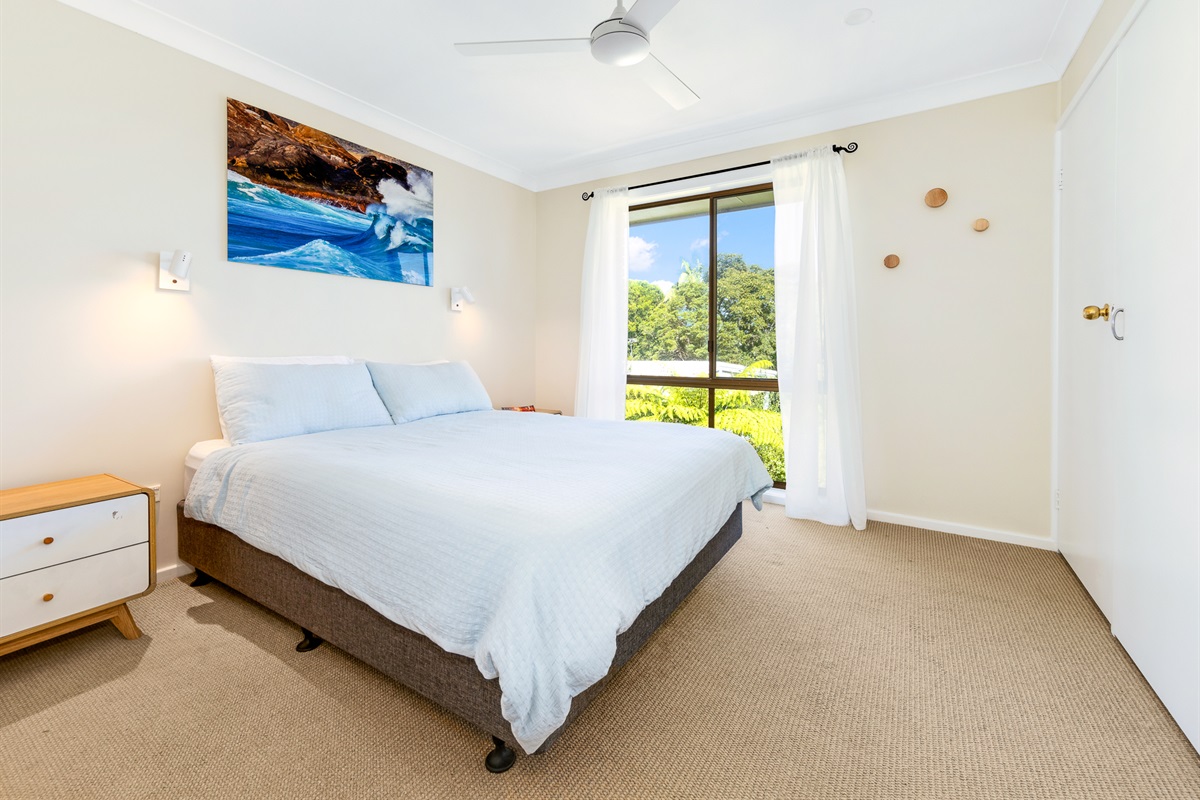 The upstairs main queen bedroom gives Bertie’s 3 Beaches a calm sleeping space positioned near the home’s main shared areas.