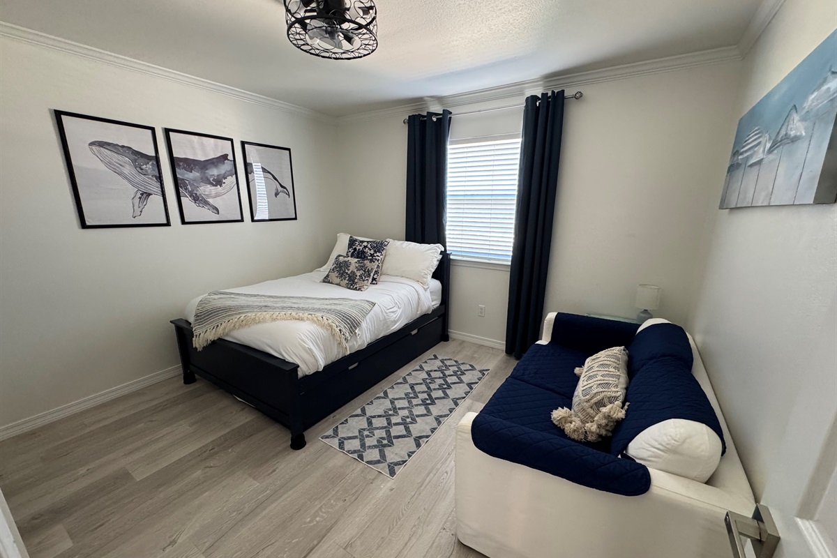 Third bedroom with full bed and trundle underneath.  Loveseat sofa as well