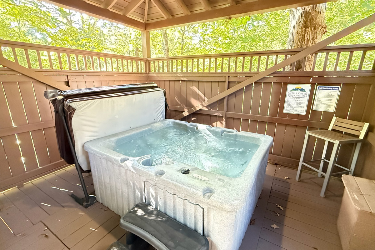 Soak away the day in your private hot tub surrounded by the woods
