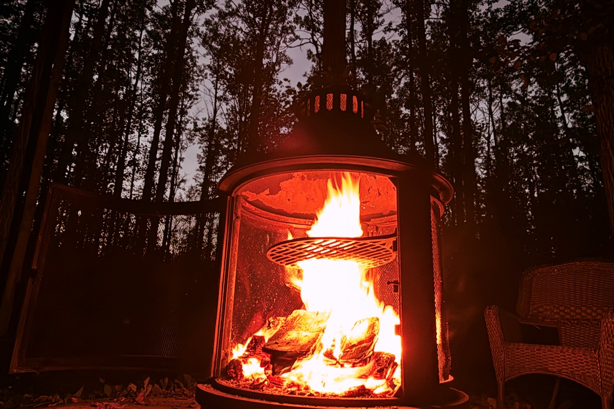 Outdoor wood fire glowing in the evening