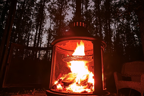 Outdoor wood fire glowing in the evening