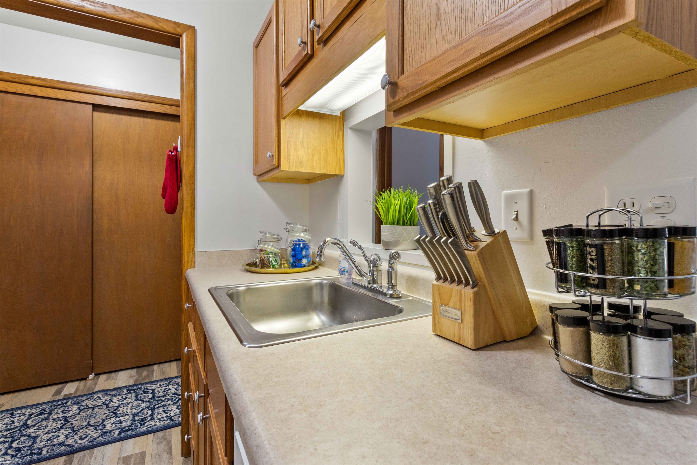 Knife block, spice rack, coffee, creamer, sugar and tea.