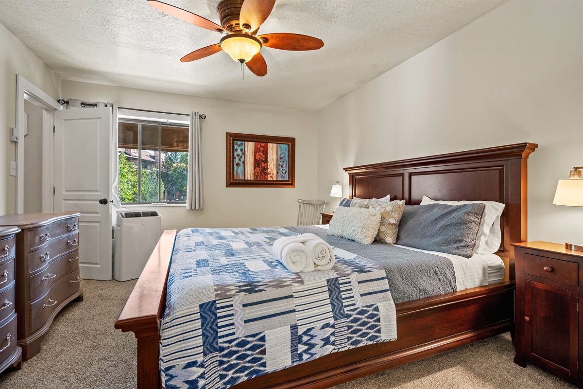 Spacious primary suite with plush bedding for a restful night’s sleep.