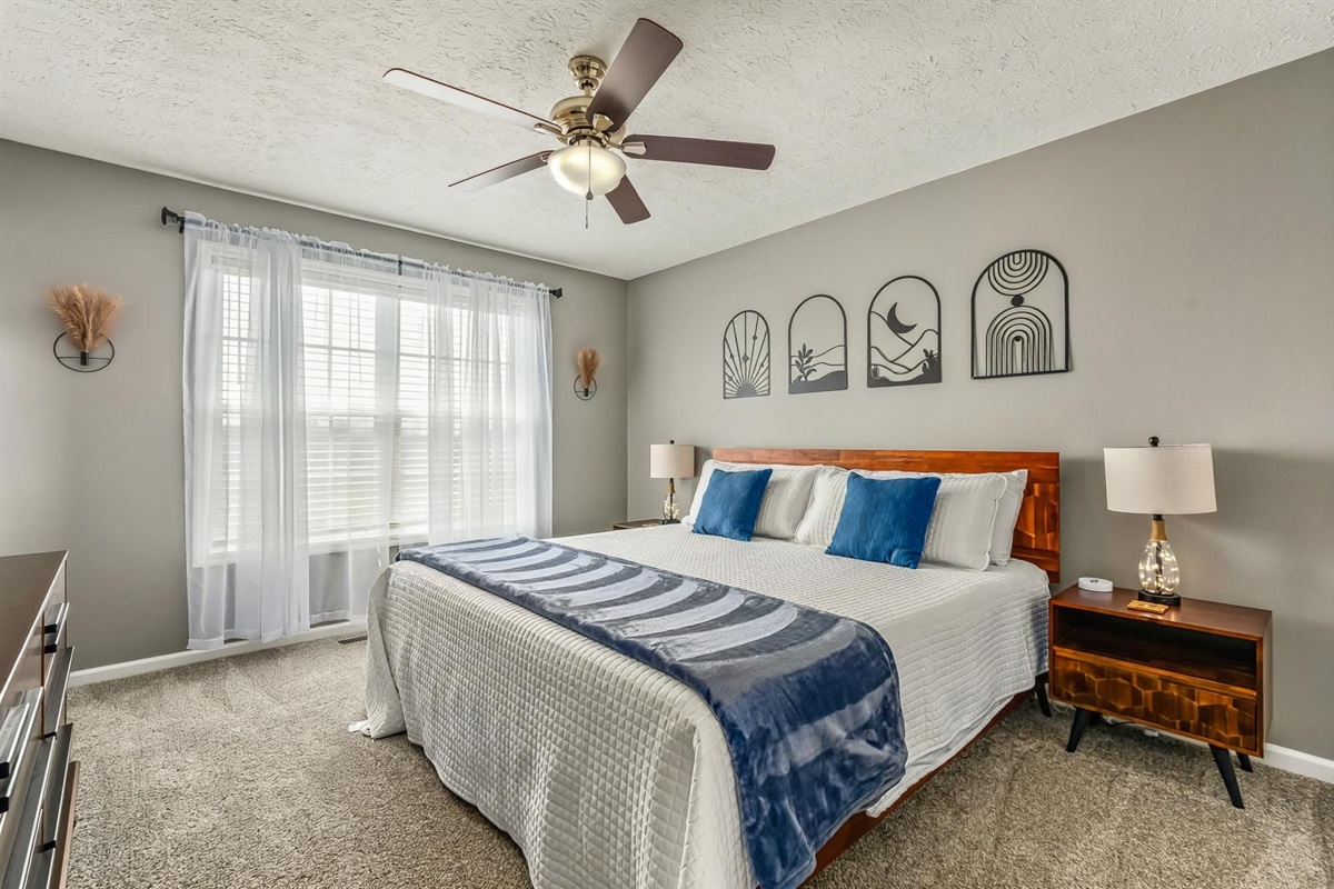 Master Bedroom with King size bed. Each bedroom has a mirror for helping with getting ready.