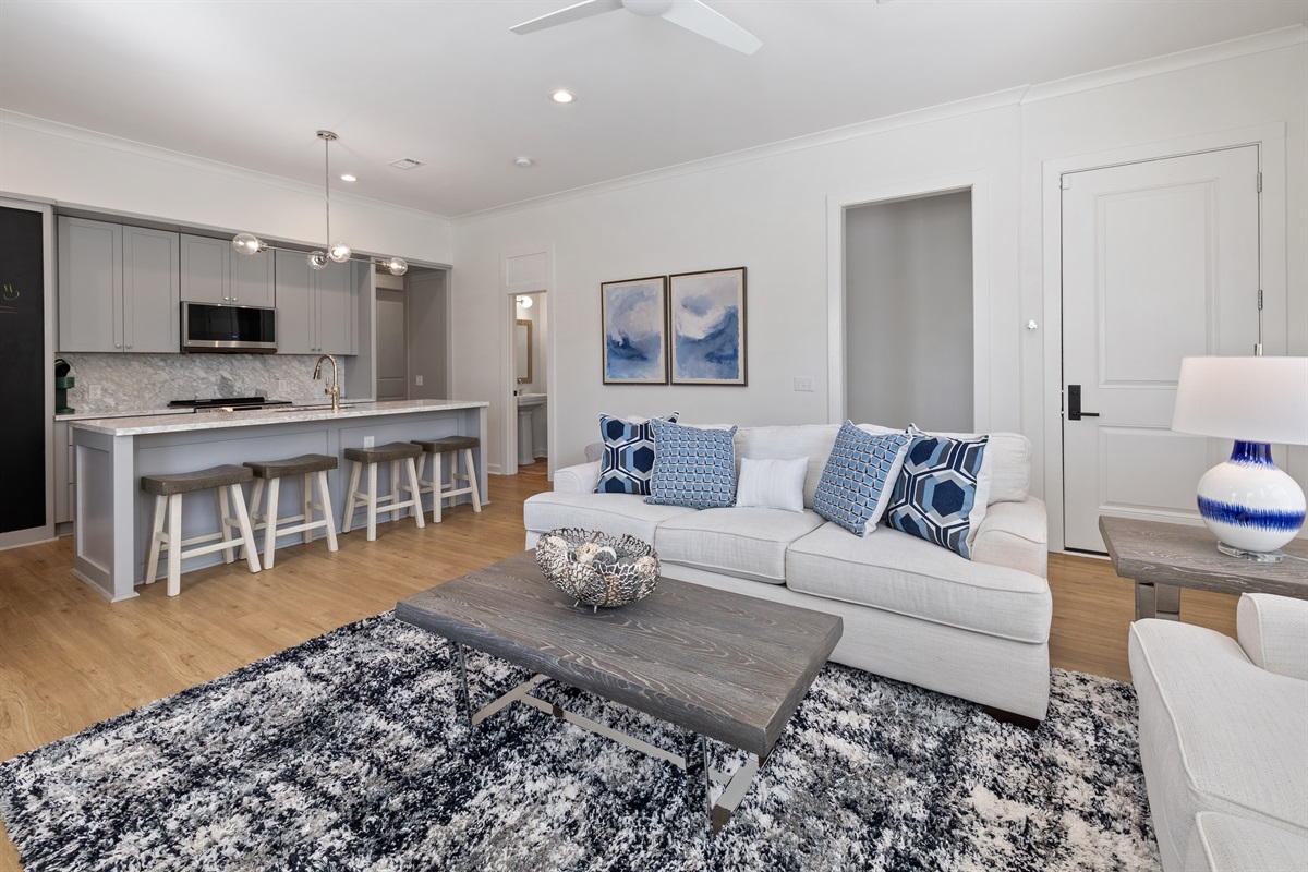 Open-concept living space filled with natural light and soft coastal hues.