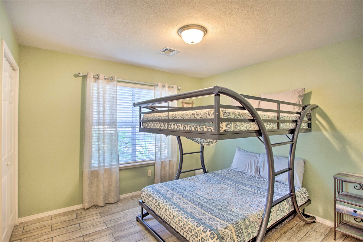Green bedroom with full over full bunk bed