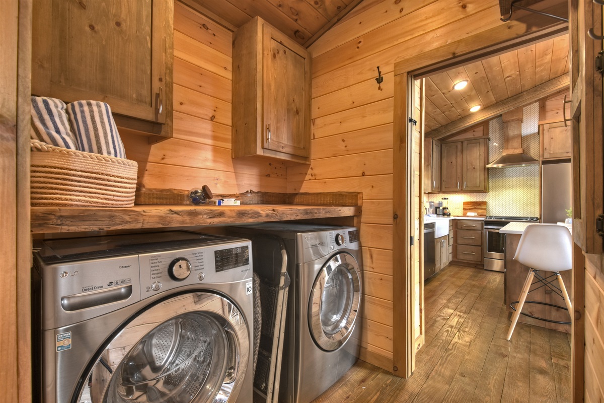 Laundry room in hallway to shared bathroom