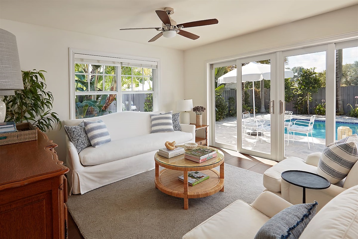 Comfortable and stylish living room with serene views overlooking the pool.
