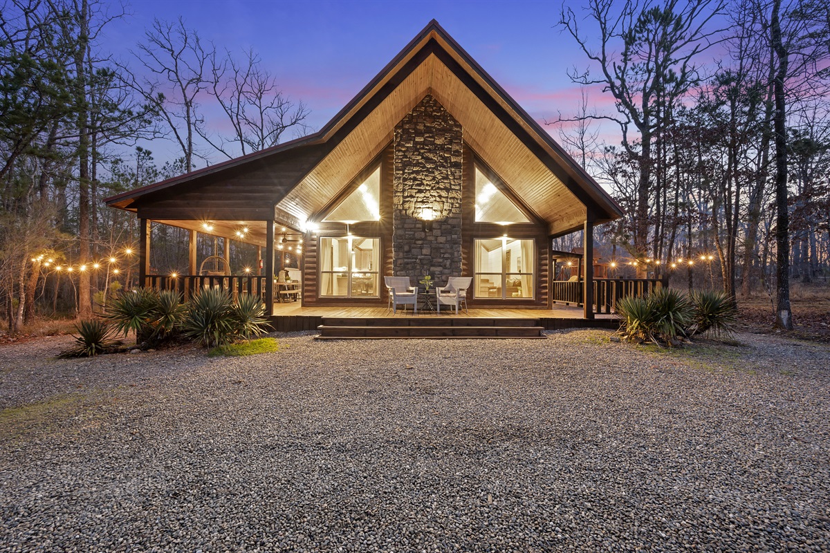 our Home Away from Home Awaits! Step into serenity as you approach our beautifully adorned exterior front. With its inviting ambiance and picturesque surroundings, our cabin promises a cozy retreat and unforgettable memories. Book your stay now and