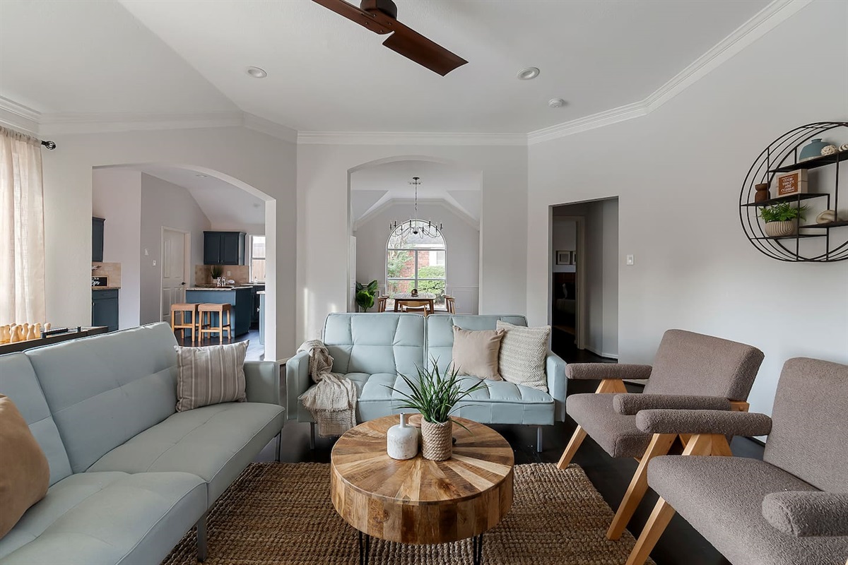 Welcome to our inviting living space with cozy sofas and a sleek TV setup. Shaded windows bring in just the right amount of natural light, creating a perfect balance of comfort and ambiance.