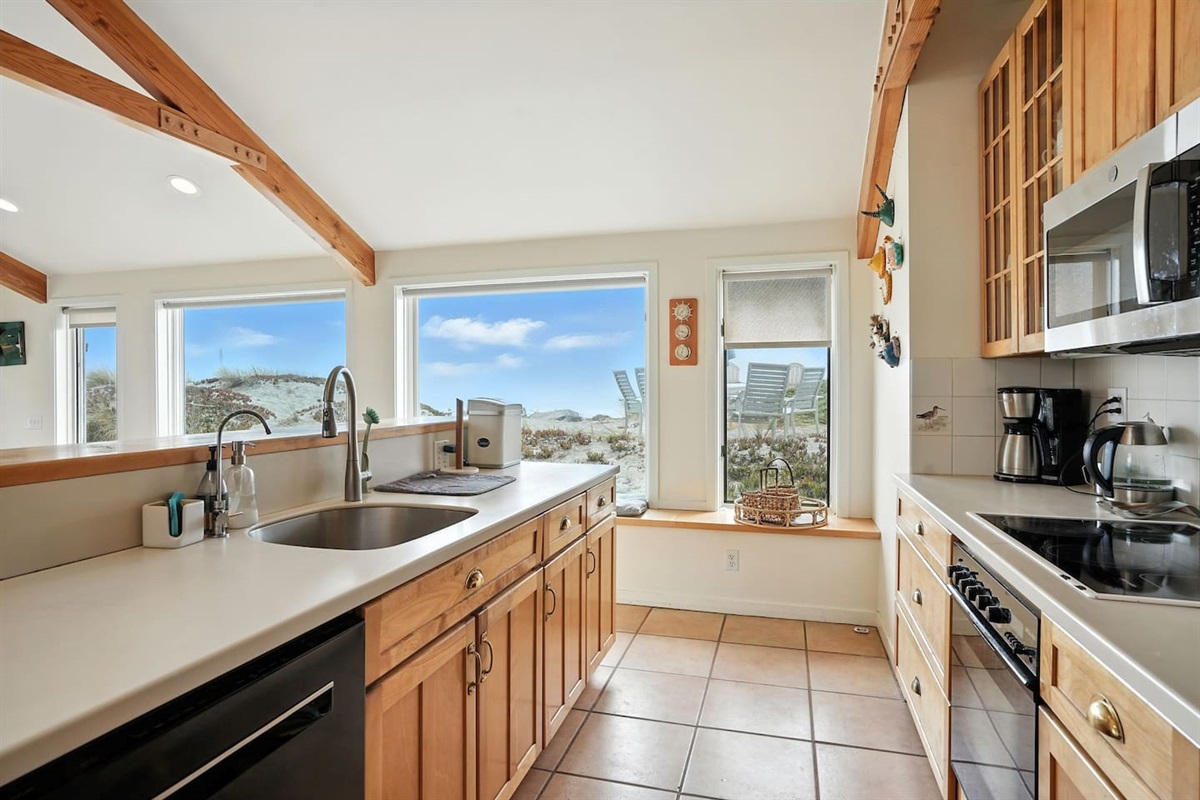 - Spacious kitchen with long counter space and deep sink, ideal for group meal prep  
- Large windows provide natural light and sweeping views of surrounding dunes  
- Fully equipped with modern appliances and wooden cabinetry for warmth