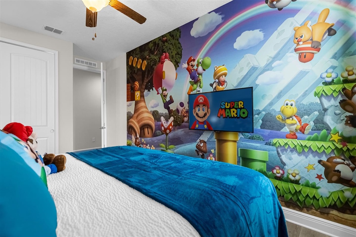 Mario-themed room featuring a king-size bed and a TV, offering a fun and vibrant space for guests to enjoy a playful and unique stay experience.