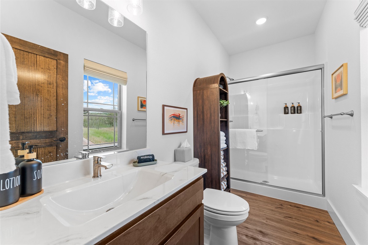 The fishing room ensuite has a full-size walk in shower with linen shelf and vanity.